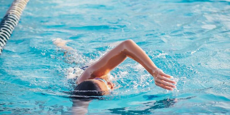 Swimming Skills - A Person Doing a Freestyle Swimming in the Pool