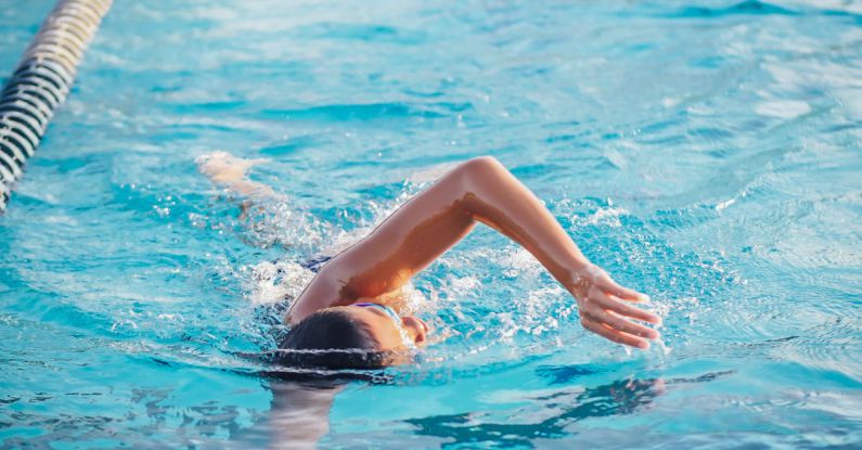 Swimming Skills - A Person Doing a Freestyle Swimming in the Pool