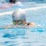Solo Swimmers - A swimmer in a pool with goggles on