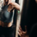 Kick Power - Woman in Gray Tank Top and Black Leggings