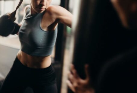 Kick Power - Woman in Gray Tank Top and Black Leggings