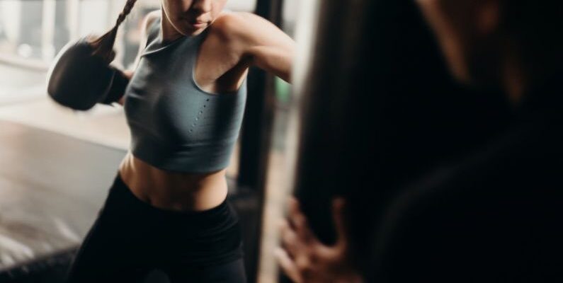 Kick Power - Woman in Gray Tank Top and Black Leggings