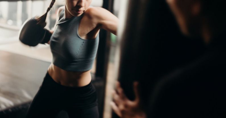 Kick Power - Woman in Gray Tank Top and Black Leggings