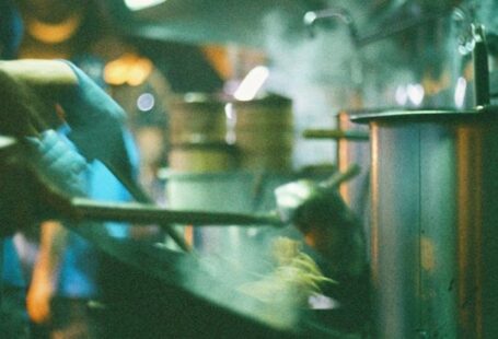 Pool Noodles - A man in a kitchen cooking food in a restaurant