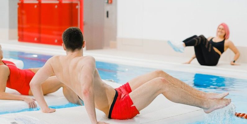 Water Aerobics - People Exercising on Floating Boards in a Swimming Pool