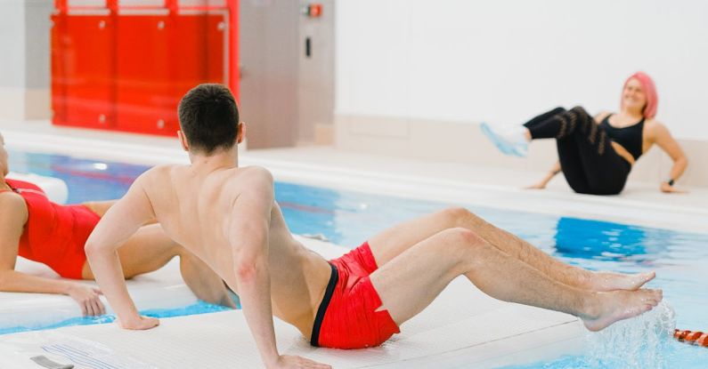 Water Aerobics - People Exercising on Floating Boards in a Swimming Pool