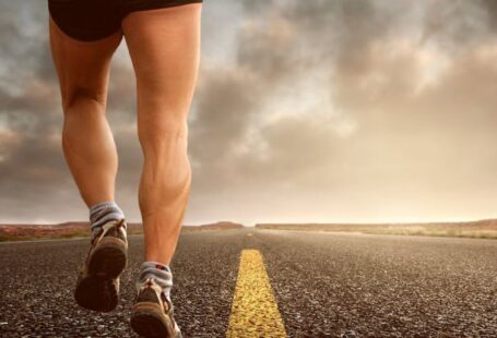 Endurance - Low Angle Photography Man Walking on Asphalt Road