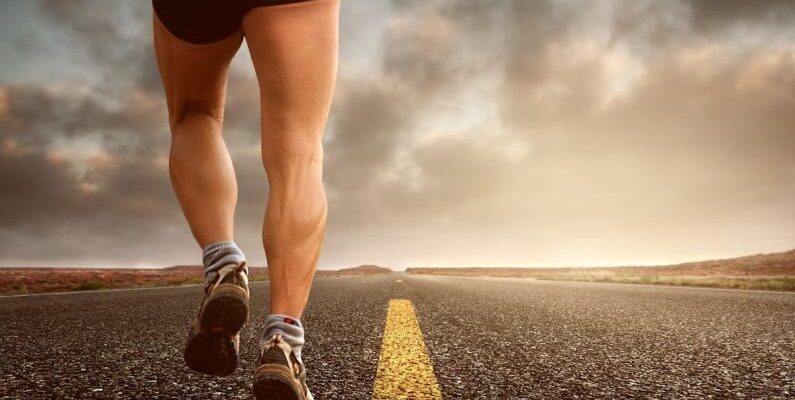 Endurance - Low Angle Photography Man Walking on Asphalt Road