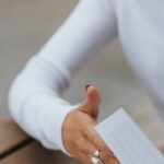 Flip Turn - Serious woman reading book at table in street cafe