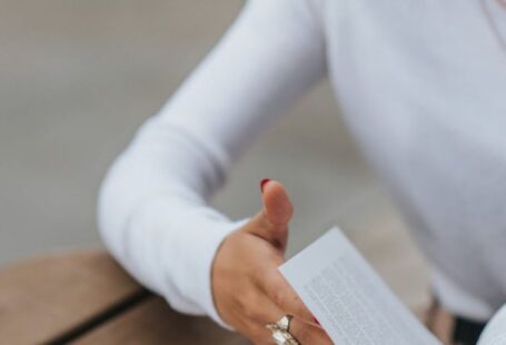 Flip Turn - Serious woman reading book at table in street cafe