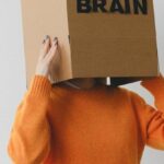 Lung Capacity - Crop person putting Idea title in cardboard box with Brain inscription on head of female on light background