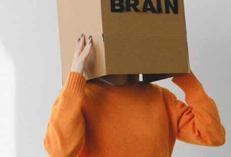 Lung Capacity - Crop person putting Idea title in cardboard box with Brain inscription on head of female on light background