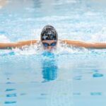 Swim Training - A swimmer in the pool with her arms outstretched