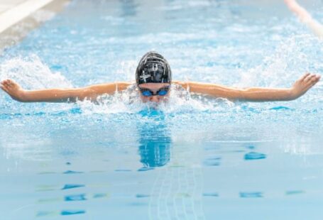 Swim Training - A swimmer in the pool with her arms outstretched