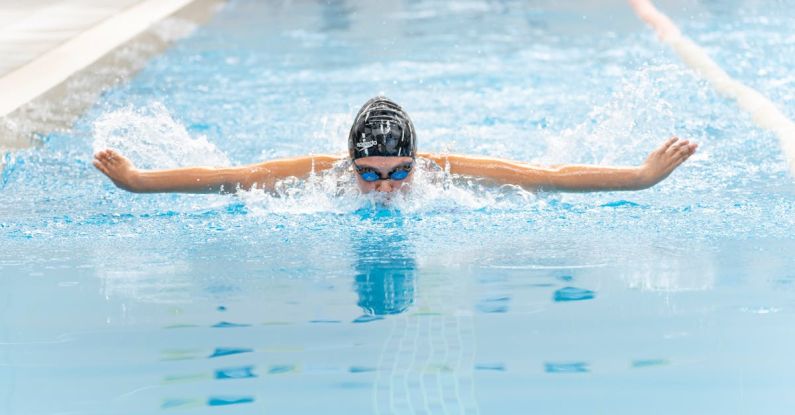 Swim Training - A swimmer in the pool with her arms outstretched