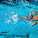 Water Games - Person Swimming on Body of Water