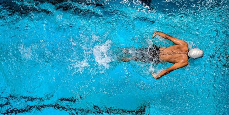 Water Games - Person Swimming on Body of Water