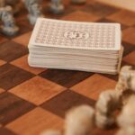 Mental Strategies - Chessboard with chess pieces and game of cards