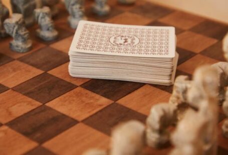 Mental Strategies - Chessboard with chess pieces and game of cards
