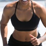 Core Muscles - Woman Wearing Black Sports Bra and Jogger Shorts Smiling