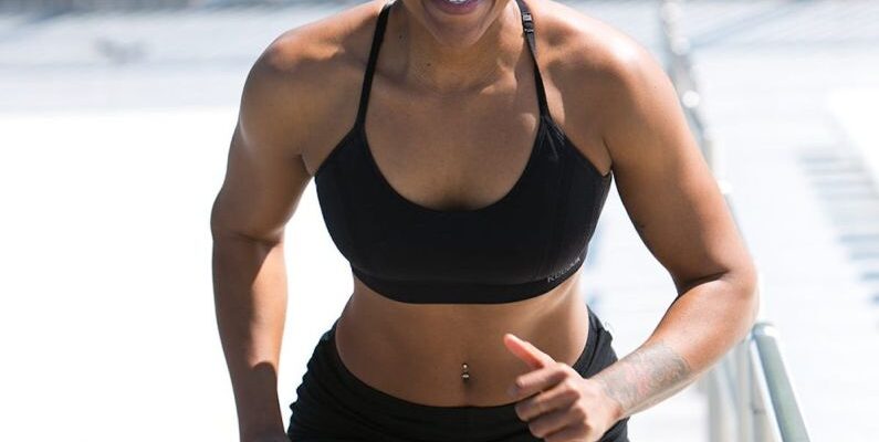 Core Muscles - Woman Wearing Black Sports Bra and Jogger Shorts Smiling