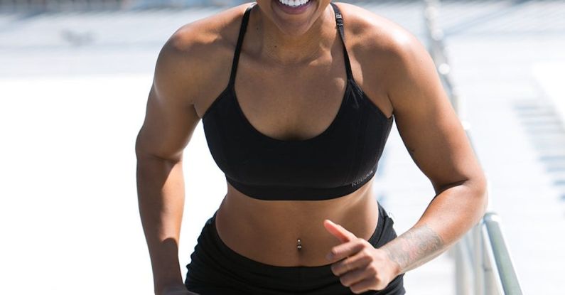 Core Muscles - Woman Wearing Black Sports Bra and Jogger Shorts Smiling