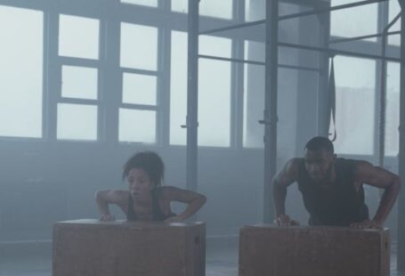 Plyometric Workouts - A Man and Woman Doing Push Ups on Plyometric Boxes