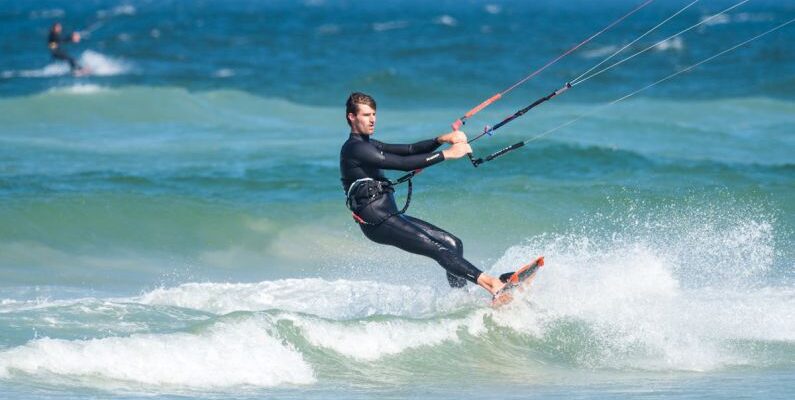 Wetsuit - Man Parasailing While Wearing Wetsuit